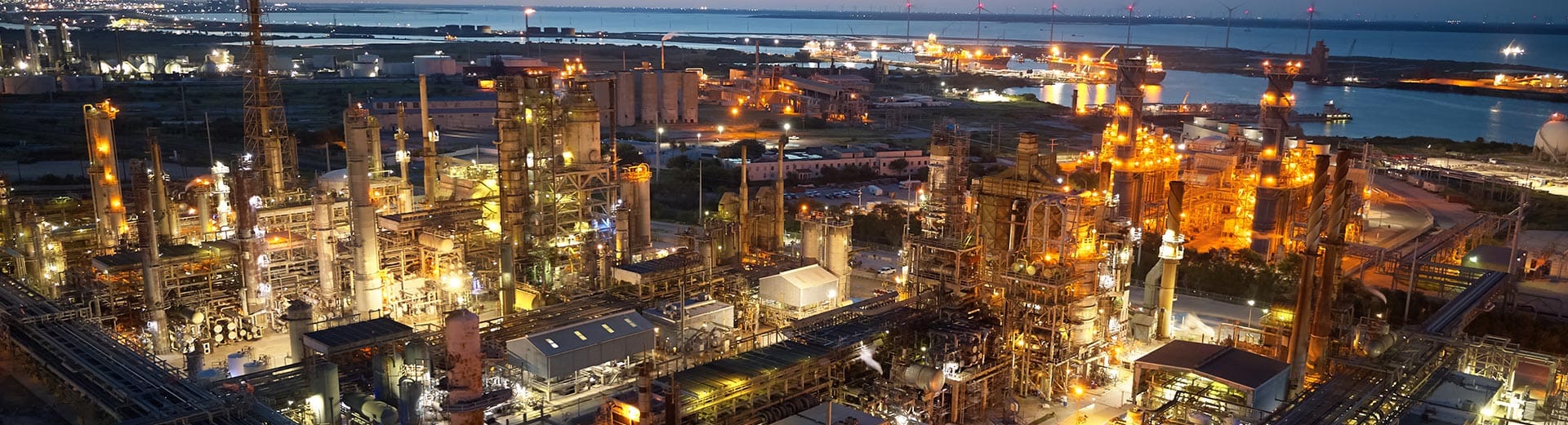 Night view of illuminated petrochemical plant.