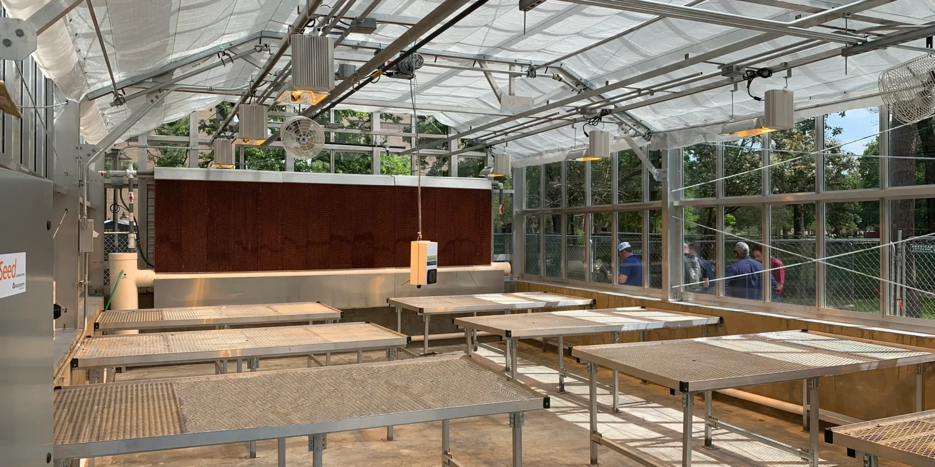 Interior of a modern greenhouse with grow tables.