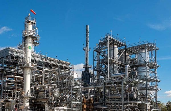 Industrial refinery plant under blue sky.