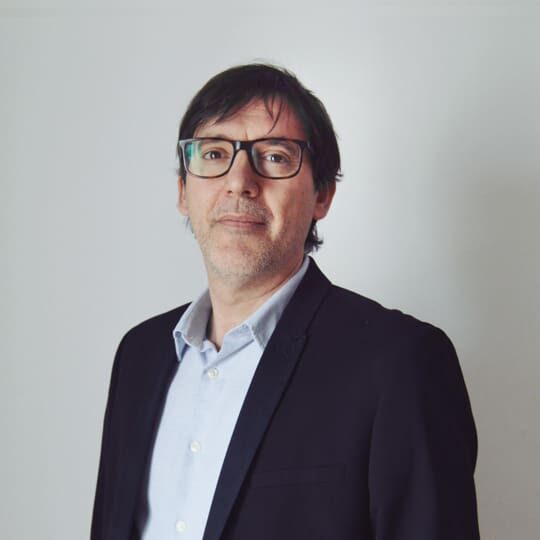 Man in suit and glasses headshot.